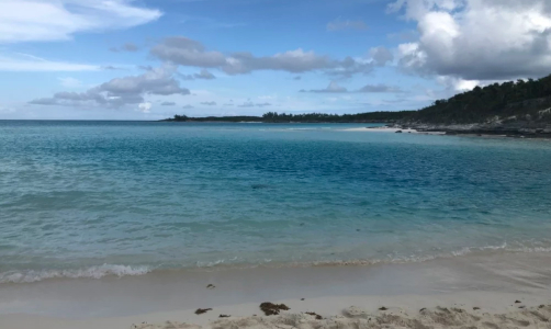 a secluded beach on a cloudy day
