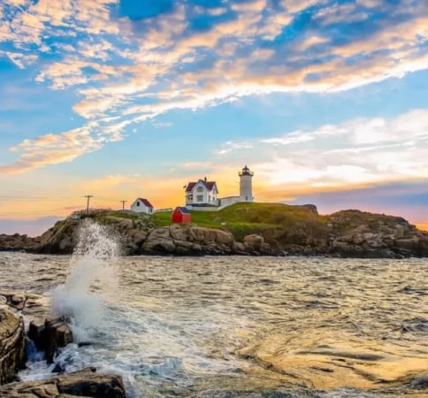 lighthouse on a rocky peninsula. Another luxury yacht charter destination.