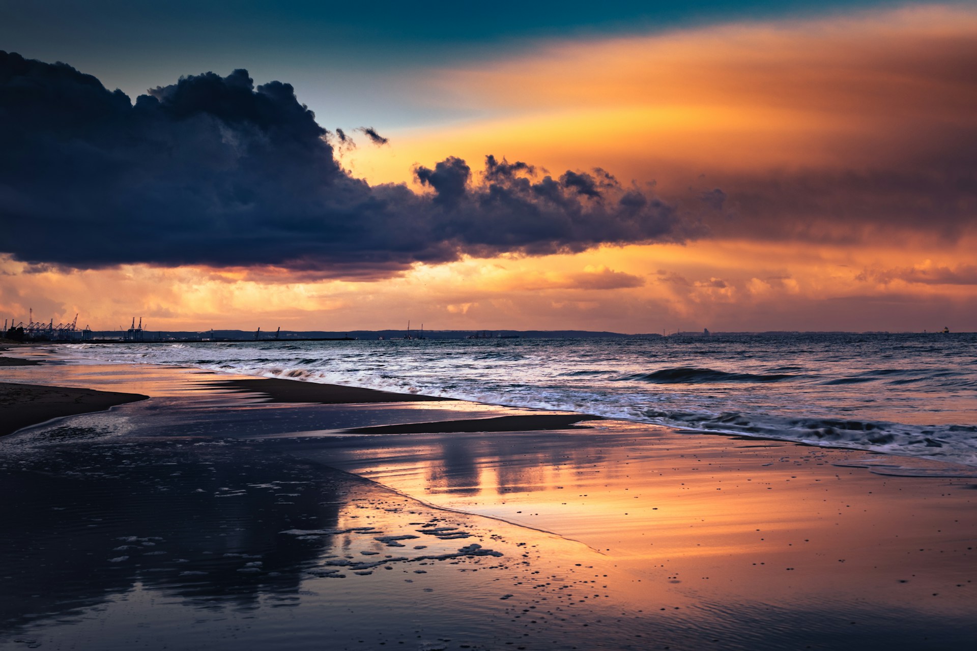 the shoreline of a beach at sunset