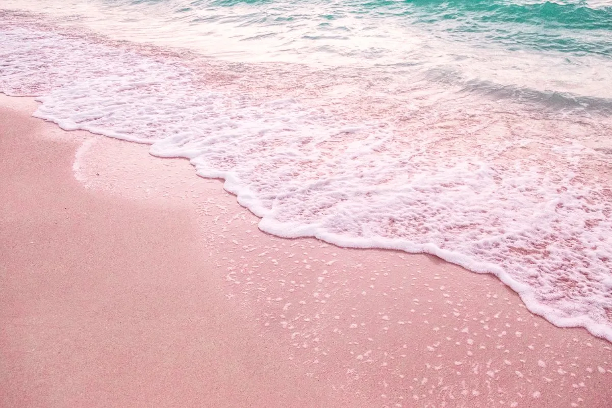 a wave on the ocean shore around sunset
